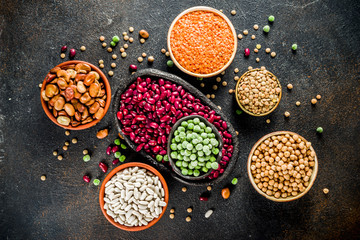 Various assortment of legumes - beans, soy beans, chickpeas, lentils, green peas. Healthy eating concept. Vegetable proteins. White marble background copy space top view