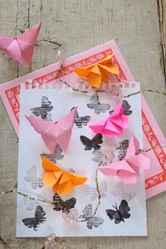 Origami butterflies on printed paper