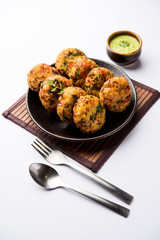 Crispy Corn Tikki, pakora/pakoda or pattice also known as cutlet. served with green chutney. Selective focus