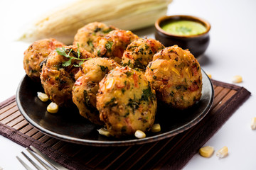 Crispy Corn Tikki, pakora/pakoda or pattice also known as cutlet. served with green chutney. Selective focus
