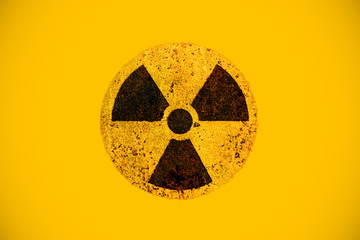 Round yellow and black radioactive hazard (ionizing radiation) nuclear danger warning symbol on...
