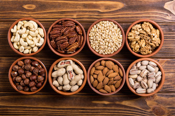 Mix of nuts : Pistachios, almonds , walnuts , pine nut , hazelnuts and cashew . Snack in bowl backgrond