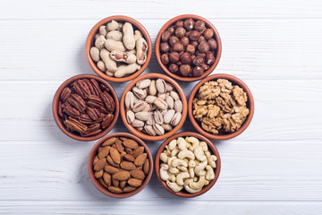 Mix of nuts : Pistachios, almonds , walnuts , pine nut , hazelnuts and cashew . Snack in bowl backgrond