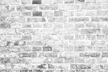 Simple grungy white grey brick wall surface as seamless pattern texture background.