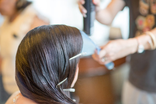 Women's haircut. hairdresser, beauty salon.soft and blur style for background.blur image of people at haircut shop.Stylist makes makeup bride on the wedding day.