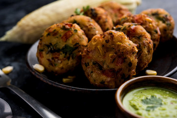 Crispy Corn Tikki, pakora/pakoda or pattice also known as cutlet. served with green chutney. Selective focus