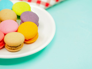 Colorful macaron cookies on pastel background, copy space.