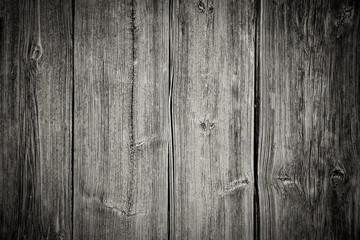 Old grungy and weathered white and grey painted wood wall plank texture background marked by long exposure to the elements outdoors and vignetting add dark corners with retro vintage look.