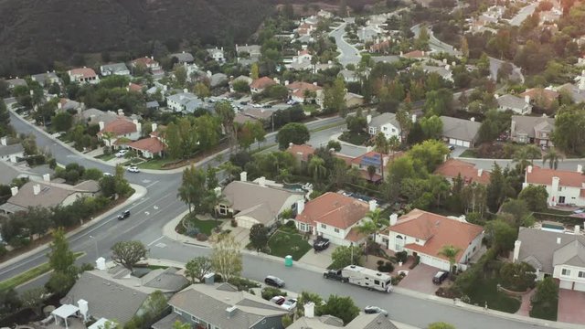 The Sunset over a residential area in between green mountiains in Southern California