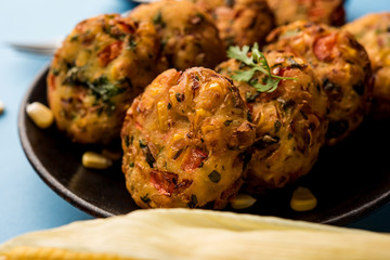 Crispy Corn Tikki, pakora/pakoda or pattice also known as cutlet. served with green chutney. Selective focus