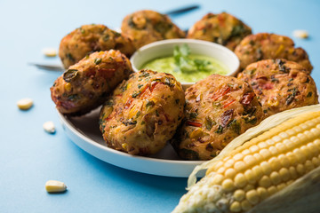 Crispy Corn Tikki, pakora/pakoda or pattice also known as cutlet. served with green chutney. Selective focus