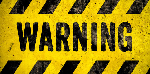 WARNING danger sign word text as stencil with yellow and black stripes painted over concrete wall cement texture wide banner background. Concept image for caution, dangerous area and hazard. - 233196212