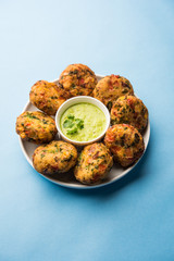 Crispy Corn Tikki, pakora/pakoda or pattice also known as cutlet. served with green chutney. Selective focus