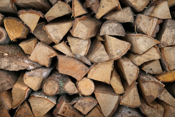 Fototapeta premium Neatly stacked wooden firewood. Stoke the fireplace. Background.