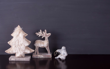 Christmas decoration. Reindeer, herder and Christmas tree