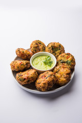 Crispy Corn Tikki, pakora/pakoda or pattice also known as cutlet. served with green chutney. Selective focus