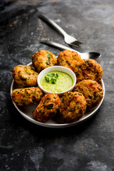 Crispy Corn Tikki, pakora/pakoda or pattice also known as cutlet. served with green chutney. Selective focus