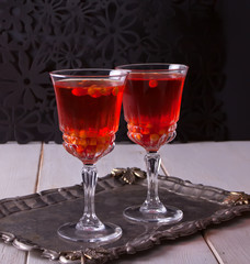Two glasses with sea buckthorn drink on the table