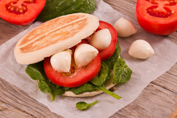 Tigella bread with spinach and tomatoes.