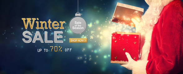 Winter sale message with Santa opening a gift box on a shiny light background