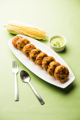 Crispy Corn Tikki, pakora/pakoda or pattice also known as cutlet. served with green chutney. Selective focus