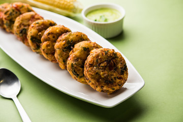Crispy Corn Tikki, pakora/pakoda or pattice also known as cutlet. served with green chutney. Selective focus
