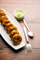 Crispy Corn Tikki, pakora/pakoda or pattice also known as cutlet. served with green chutney. Selective focus