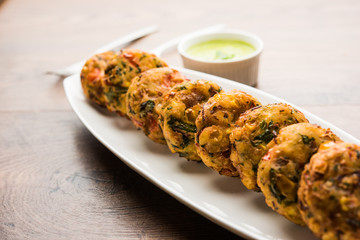 Crispy Corn Tikki, pakora/pakoda or pattice also known as cutlet. served with green chutney. Selective focus