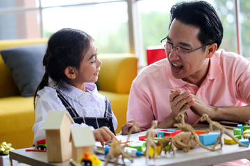 Parent and little child having fun playing educational toys,Family concept.