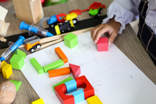 Parent and little child having fun playing educational toys,Family concept.