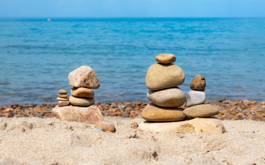 Fototapeta na wymiar Balance stones on the beach on Sicily island, Italy
