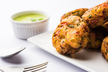 Crispy Corn Tikki, pakora/pakoda or pattice also known as cutlet. served with green chutney. Selective focus