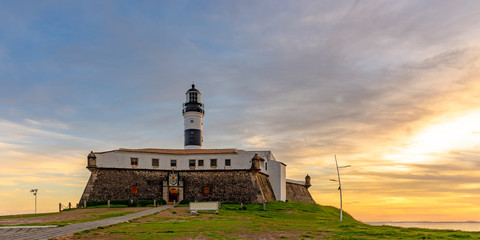 View of the famous Barra Lighthouse in Salvador, Bahia during sunset in summer in northeast Brazil