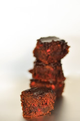 A stack of chocolate brownies isolated on white silver background, homemade bakery and dessert.