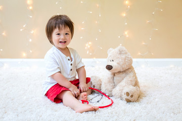 Toddler boy with teddy bear doctor pediatric theme