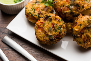Crispy Corn Tikki, pakora/pakoda or pattice also known as cutlet. served with green chutney. Selective focus
