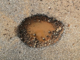 hole on asphalt road in countryside in rainy season