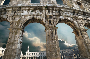 Pula amphitheatre arches with thunder sky background