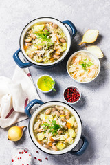 Sauerkraut red bean meat soup in pots. Top view, space for text.