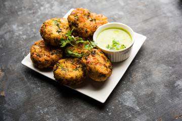 Crispy Corn Tikki, pakora/pakoda or pattice also known as cutlet. served with green chutney. Selective focus