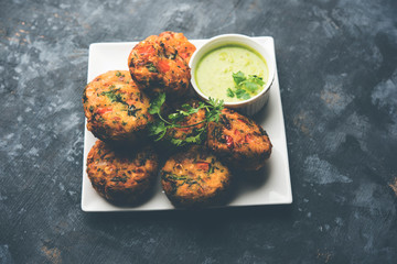 Crispy Corn Tikki, pakora/pakoda or pattice also known as cutlet. served with green chutney. Selective focus