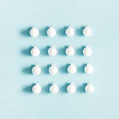 Christmas or winter composition. Pattern made of white balls on pastel blue background. Christmas, winter, new year concept. Flat lay, top view