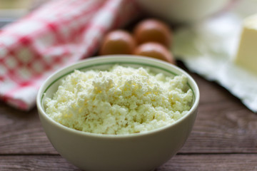 fresh cottage cheese and eggs on the table, baking ingredients