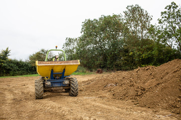 Image of front dumper truck in construction site. Copy space.