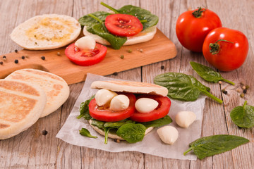 Tigella bread with spinach and tomatoes.