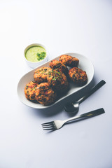 Crispy Corn Tikki, pakora/pakoda or pattice also known as cutlet. served with green chutney. Selective focus