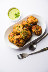 Crispy Corn Tikki, pakora/pakoda or pattice also known as cutlet. served with green chutney. Selective focus