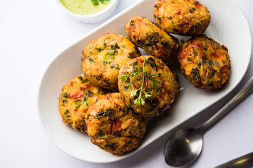 Crispy Corn Tikki, pakora/pakoda or pattice also known as cutlet. served with green chutney. Selective focus