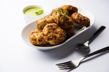 Crispy Corn Tikki, pakora/pakoda or pattice also known as cutlet. served with green chutney. Selective focus