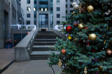 Christmas in a big city, decorated tree and giftboxes at the city square